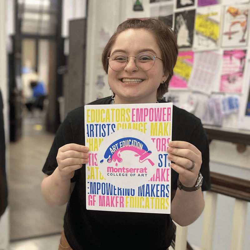 person smiling holding up a flyer
