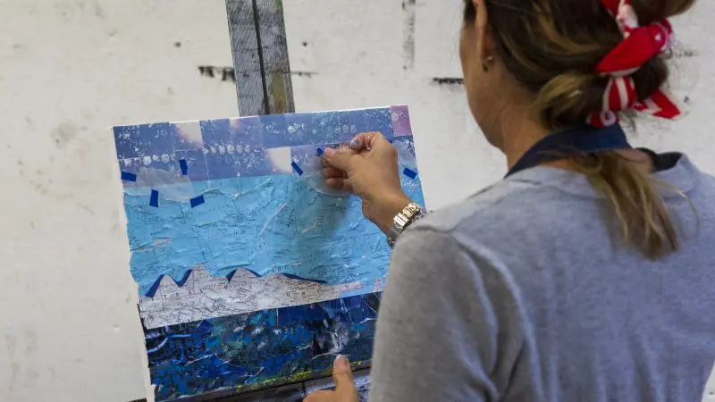 An artist making a collage