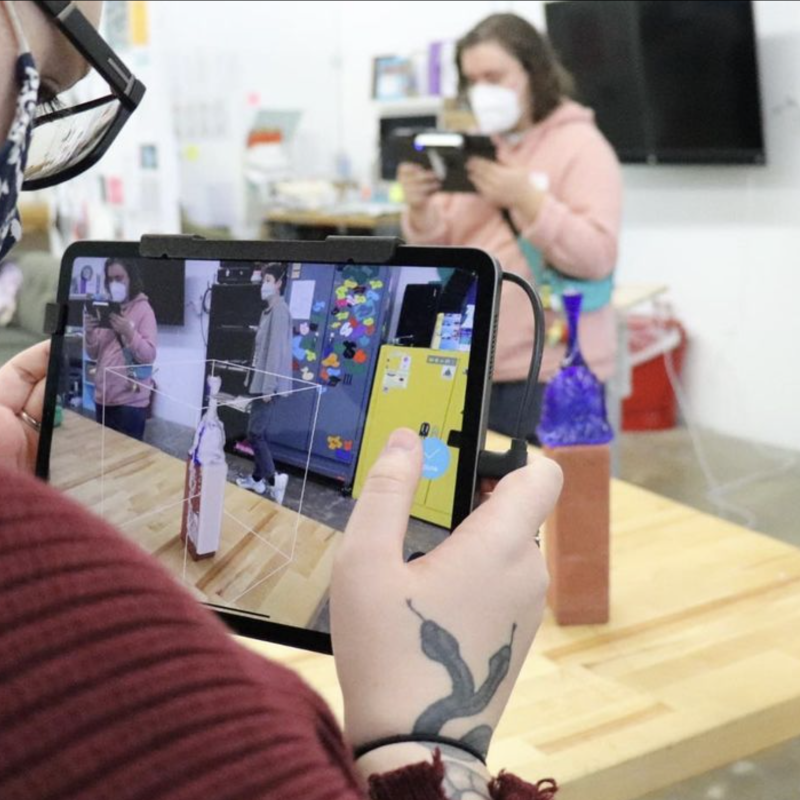 Person using an iPad to 3D scan a sculpture