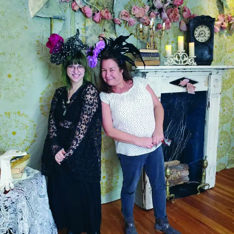 Two people wearing fancy hats