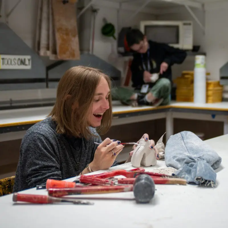 A person working on a sculpture