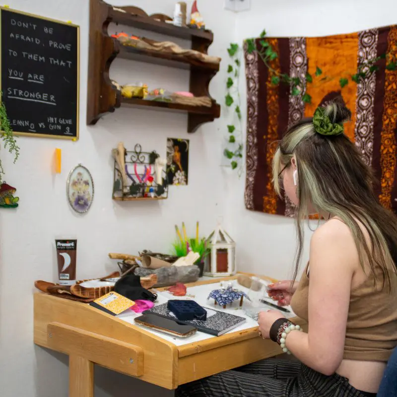A person working on a miniature sculpture at a desk