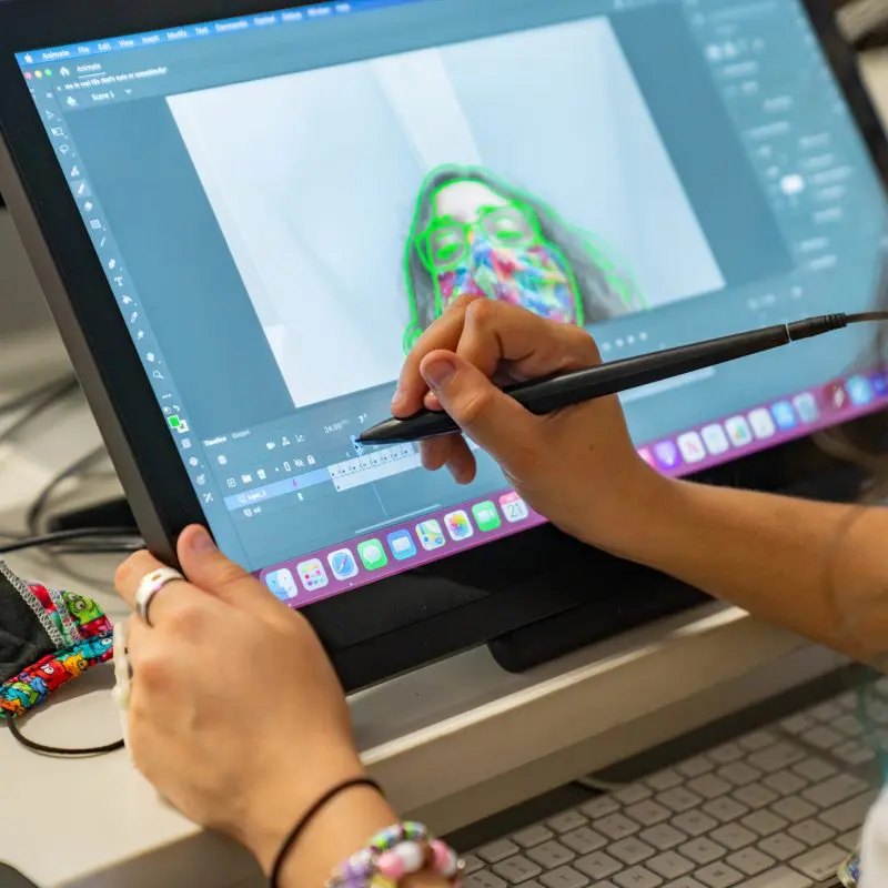 A person animating on a drawing tablet