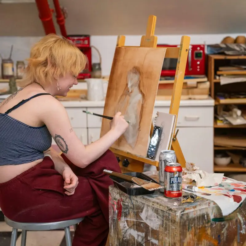 Person painting a figure