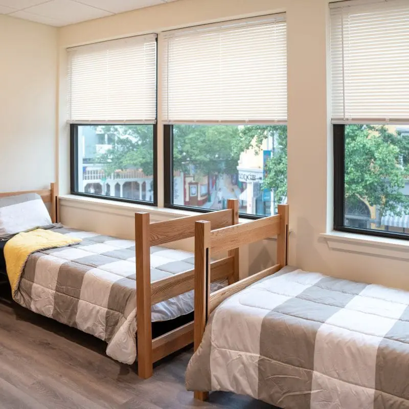 two beds with a view out the window