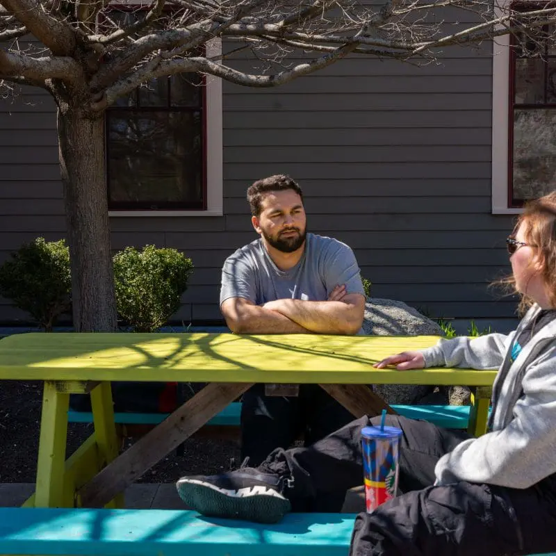 Students sitting at picnic table