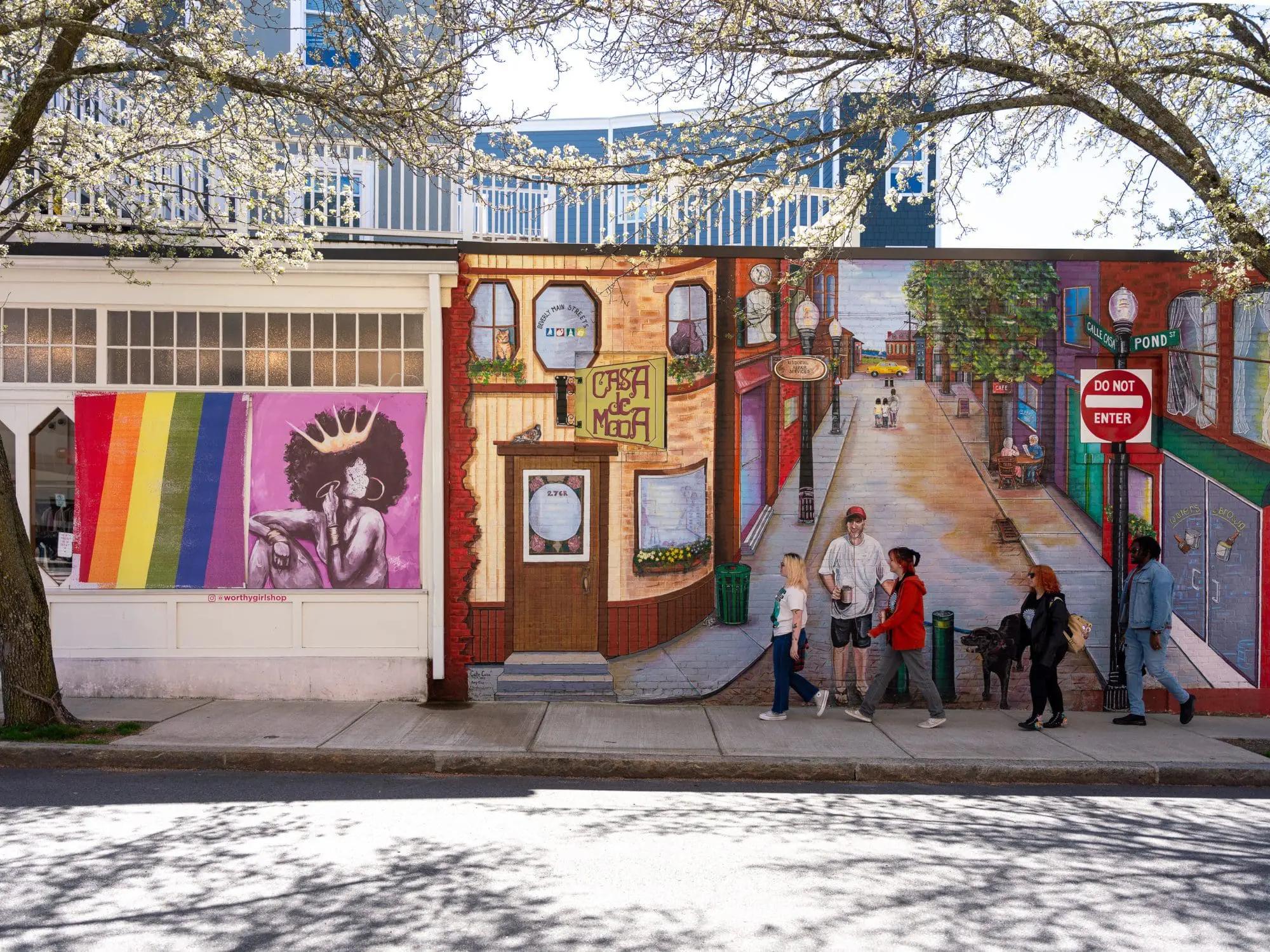 students walking in front of a mural in downtown Beverly