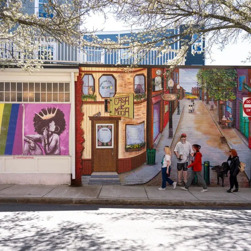 students walking in front of a mural in downtown Beverly