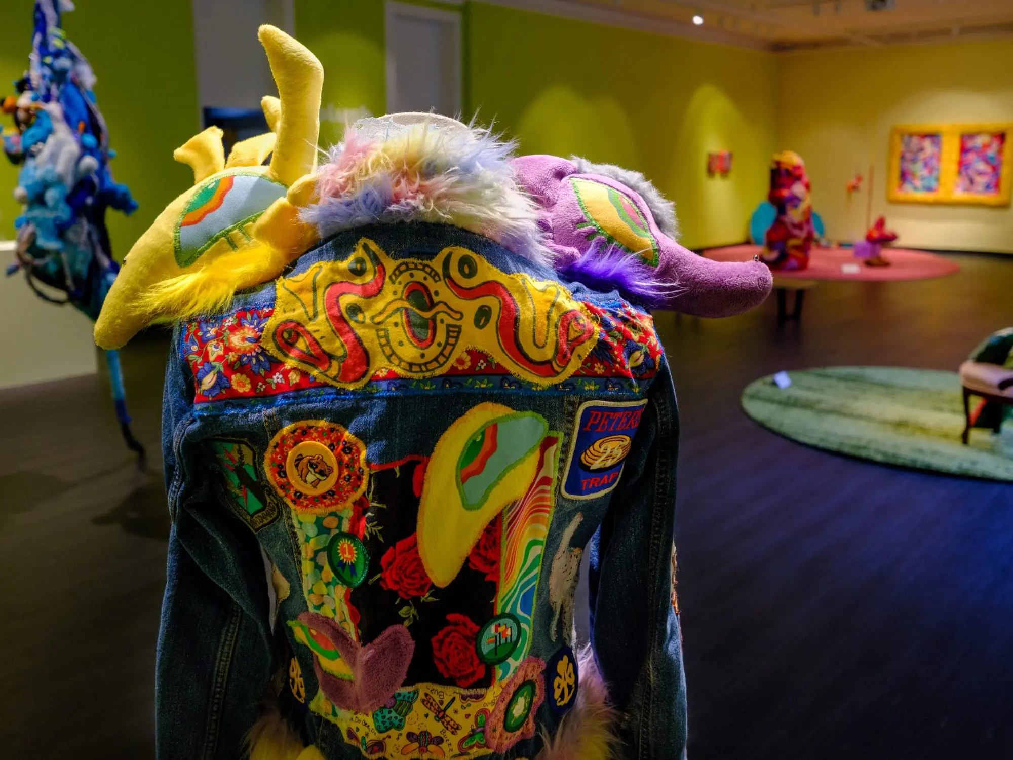 art gallery with embroidered jean jacket