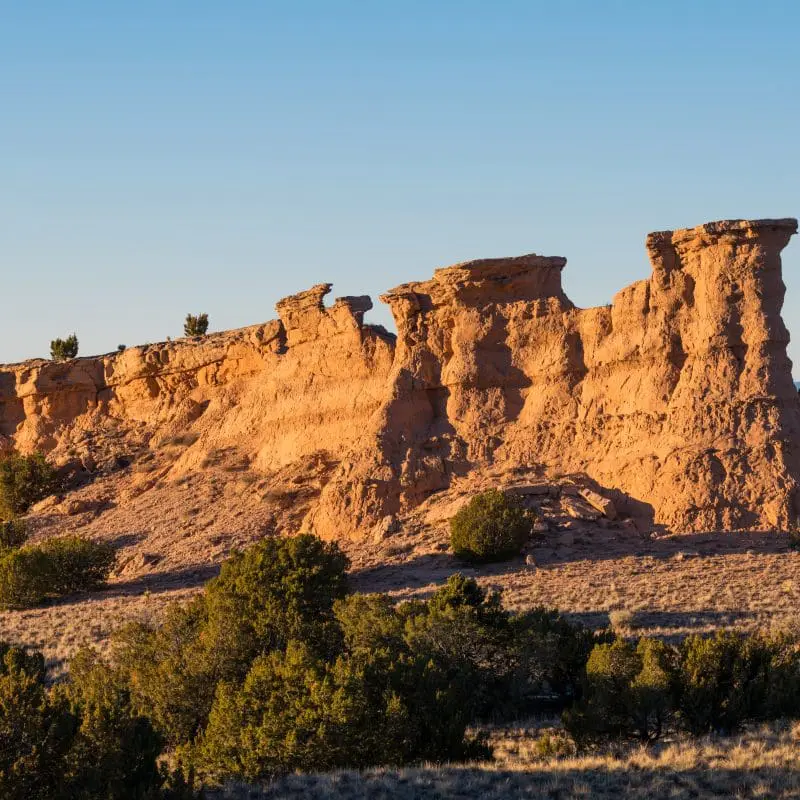 Sandstone red rock formation glowing in the golden light of sunset near Santa Fe, New Mexico