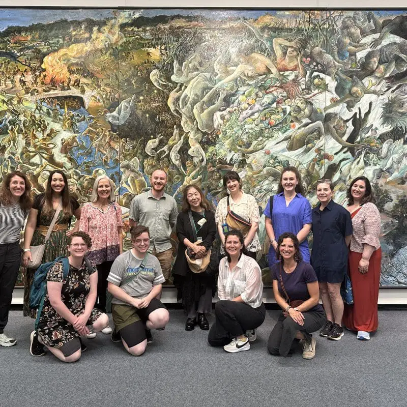 People in front of a large painting