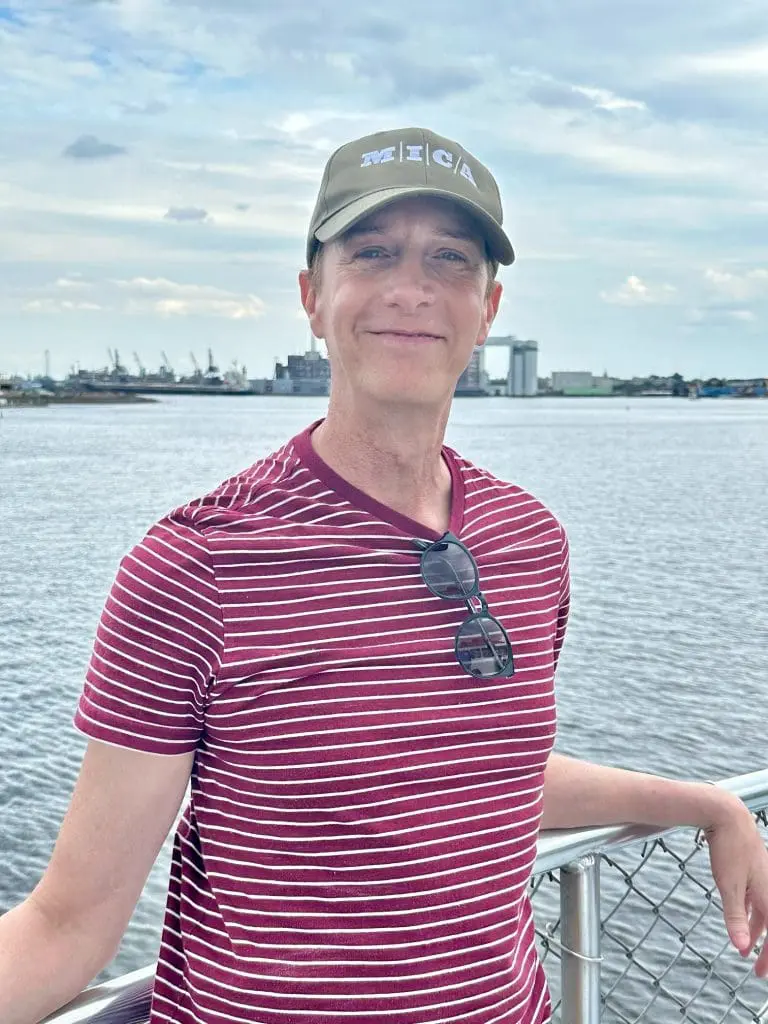 Paul Emmanuel standing in front of the ocean