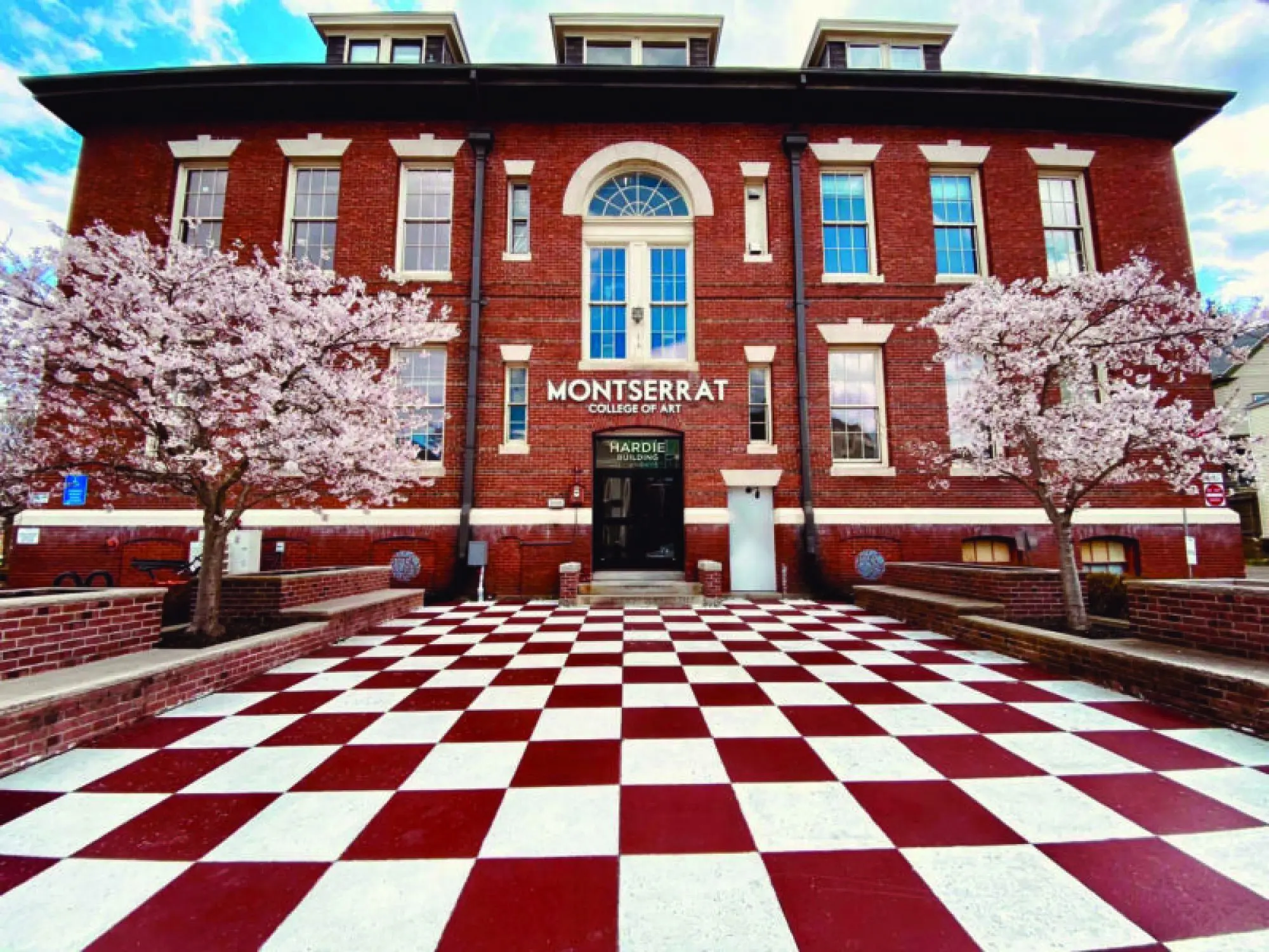 Photo of the exterior of the Hardie building with trees in bloom on both sides