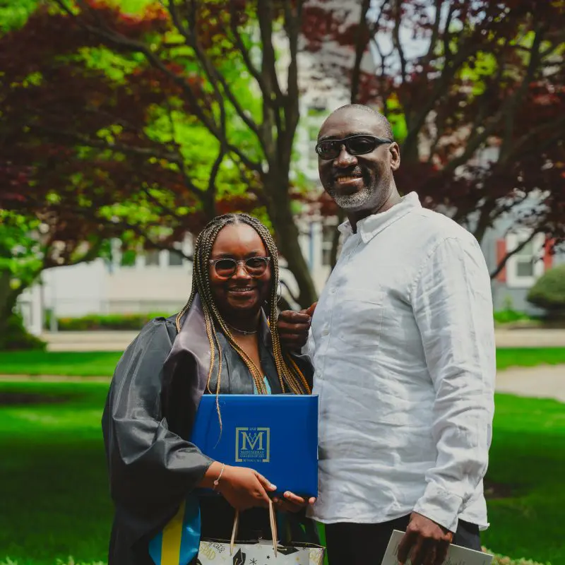 Graduate holding diploma