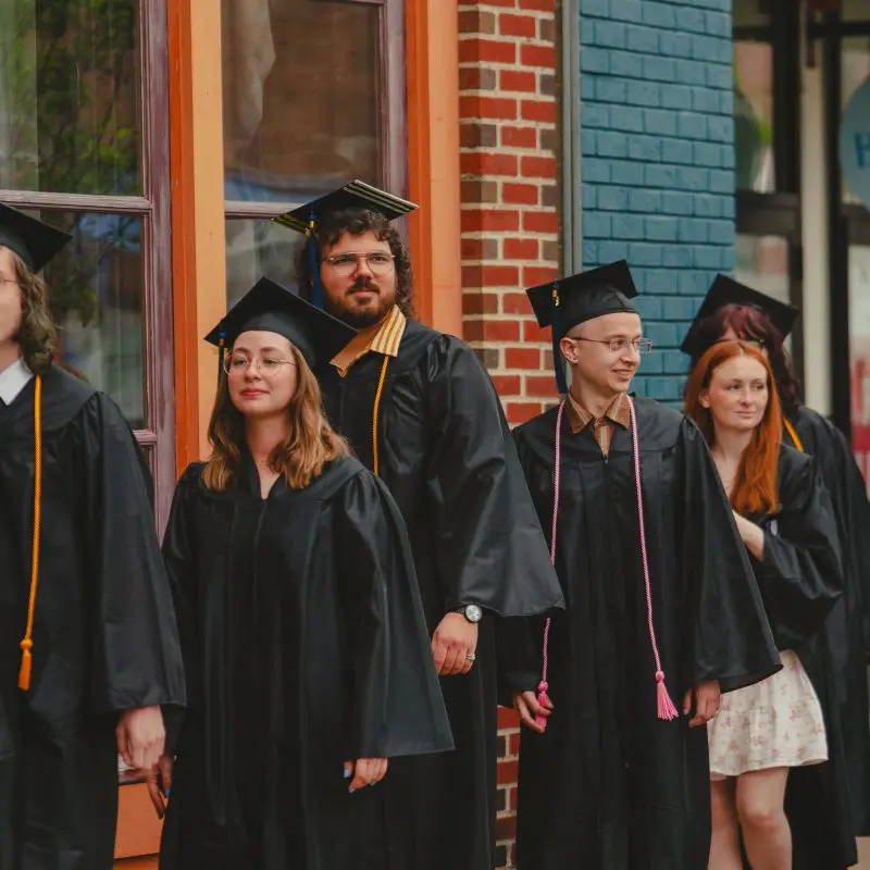 Students walking in graduation caps and gowns