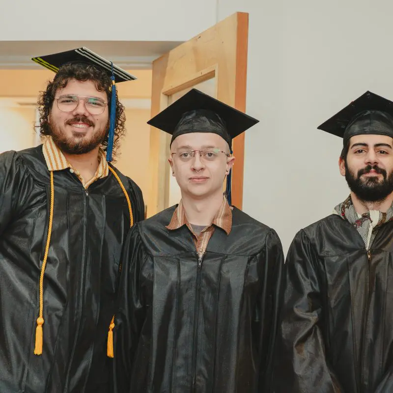 Students wearing graduation caps and gowns