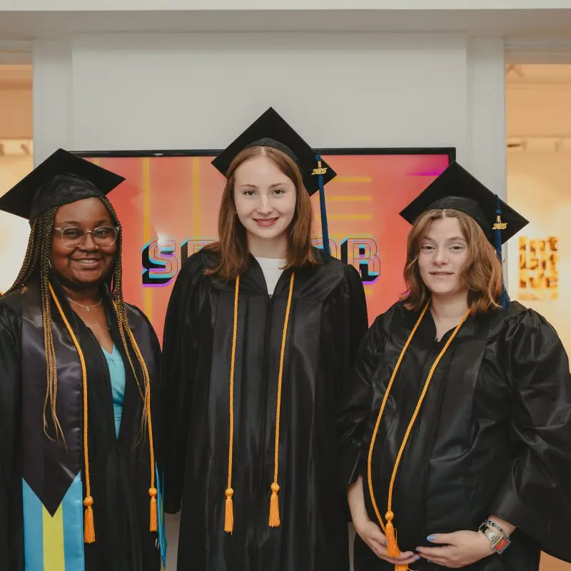 Students wearing graduation caps and gowns
