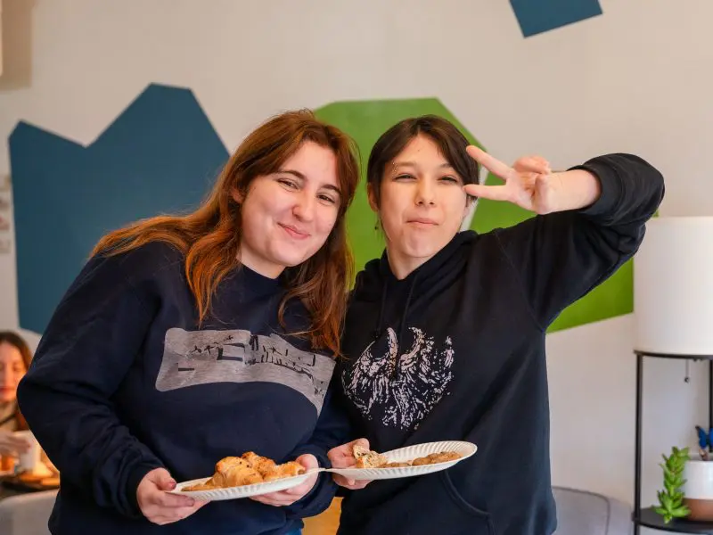 two students smiling at the camera