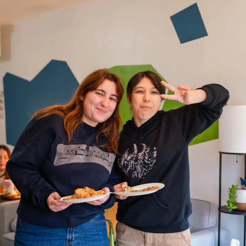two students smiling at the camera