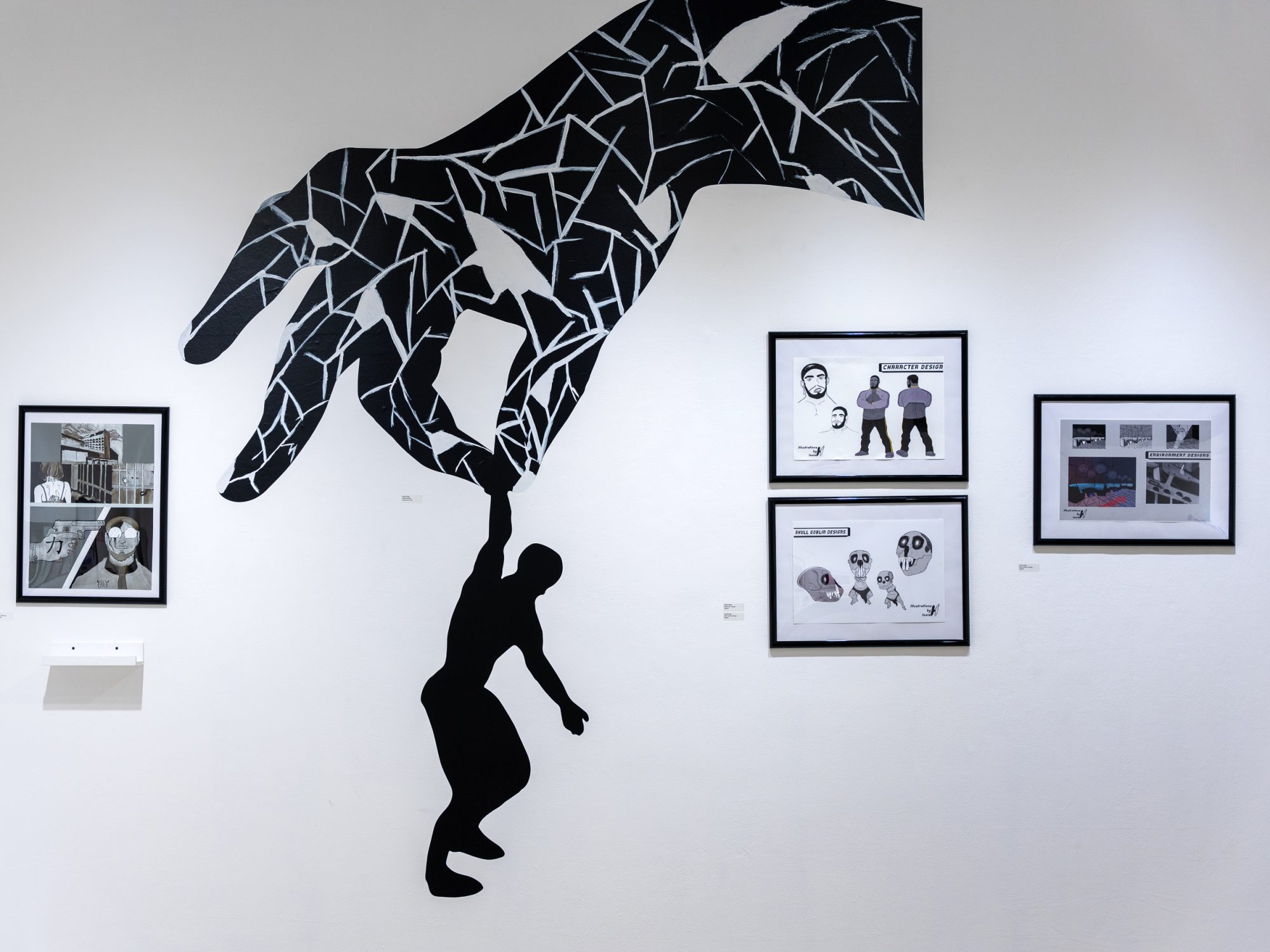 A giant, fragmented hand holding a figure, surrounded by framed comics and concept art