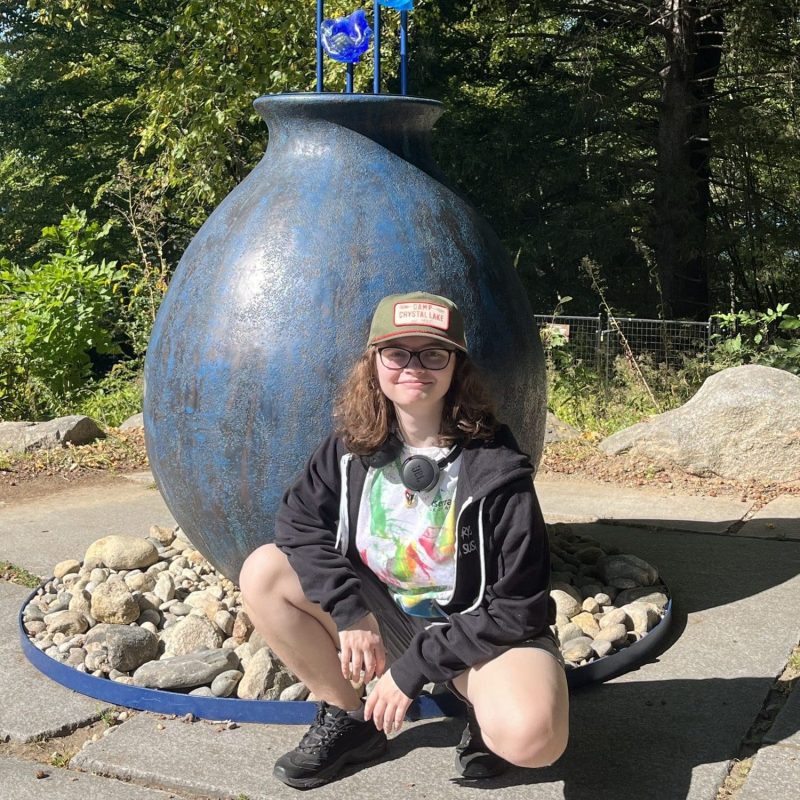 student in front of a sculpture